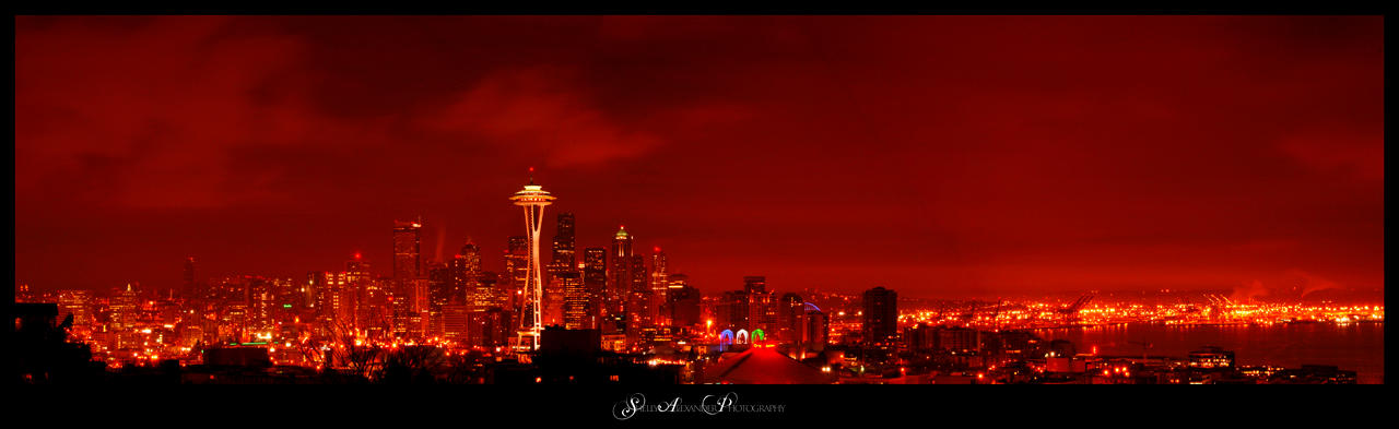 Photo of the Seattle Skyline at night covered in a red overlay effect.